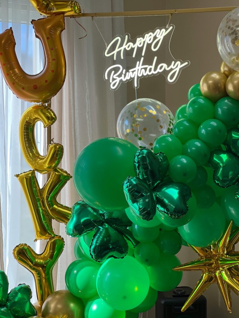St. Patricks' Day and birthday celebration balloon arrangement with green balloons, shamrock balloons and balloons that spell "Lucky".